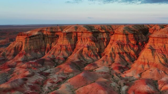 Aerial view of the colorful sedimentary rock formations of Tsagaan Suvarga at sunset in Olziit, Dundgovi, Mongolia.