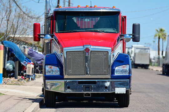Kenworth semi truck parked on a street in an industrial zone, illustrating trucking, freight transportation, logistics, industrial activity, and commercial vehicle operations
