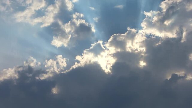 Dramatic sun rays shining through clouds
