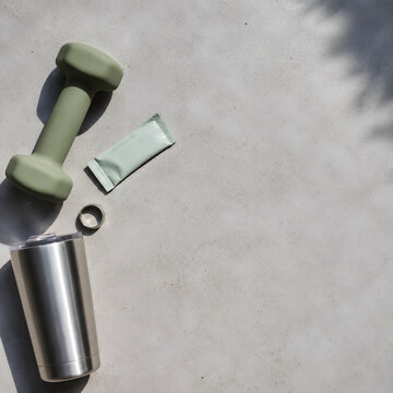 Overhead knolling flat lay of matte dumbbell and health tracker