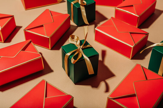 Bright red and green gift box arrangement with gold ribbon