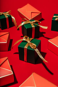 Green gift box and envelope on bright red background