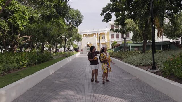 Curious tourist couple pointing at something in a park