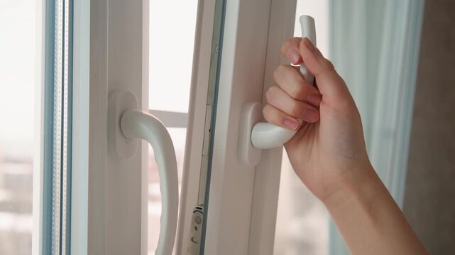 Hand opens window. Quick hand pushes open window wide. Hand rapidly swings window open to cool evening air. Clearly defined hand swiftly swings window open to reveal refreshing evening breeze