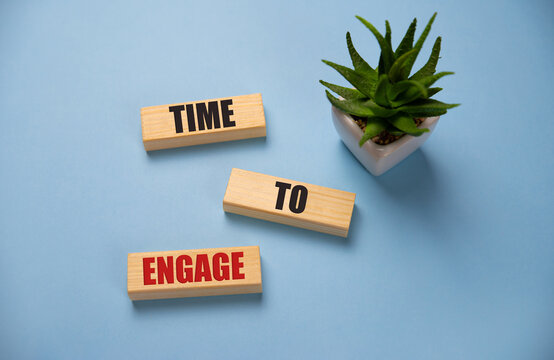 time to engage text on cubes on blue background.