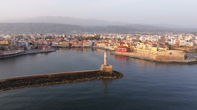  View of Chania with the amazing lighthouse, mosque, venetian shipyards, Crete, Greece.Waves crashing on lighthouse, Beautiful Greece and best scenic places - panorama