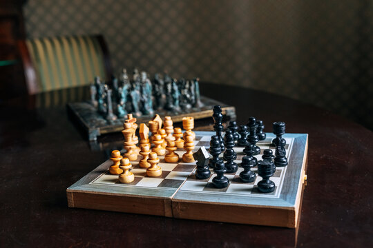 Vintage chess set with antique pieces on wooden table