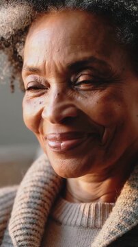 Vertical video: Noticing collar slipping, woman pulling knit shawl closer at home for comfort