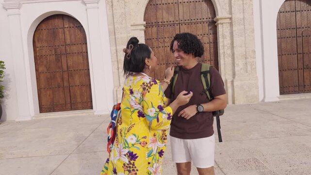 Traveling couple having fun using phone for directions