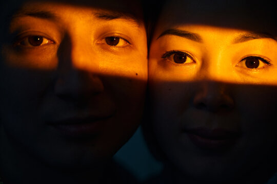 Close-up portrait of two faces in warm dramatic light