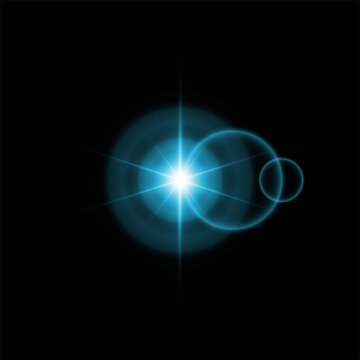 Abstract blue light flare with lens artefacts isolated on a solid black background for digital design