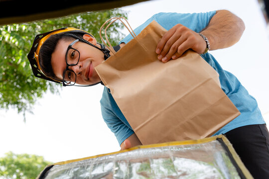 Scooter rider deliver food order in paper bag