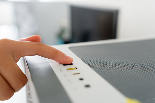 Young woman power on desktop computer for gaming