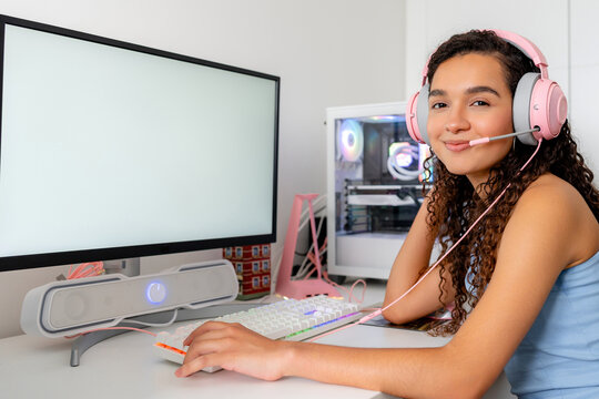 Young woman play computer game at desktop setup