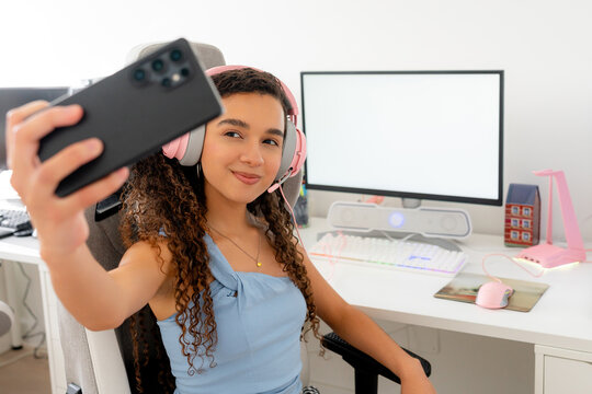 Young gamer take selfie at desktop computer setup