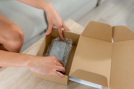 Woman pack second-hand item for online marketplace sale