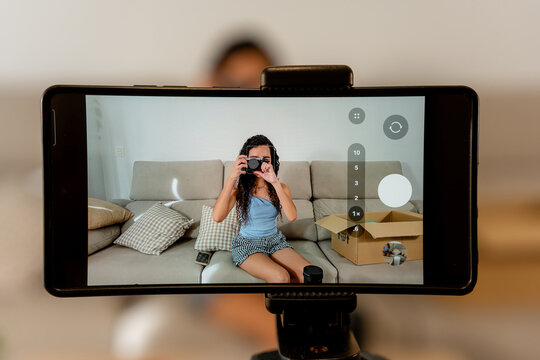 Young woman photograph second-hand item for online marketplace