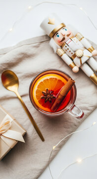 Top View Flat Lay of Mulled Wine Glass with Golden Nutcracker and Christmas Decor Leaving Empty Copy Space for Text