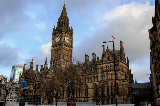 Manchester Town Hall clock tower under dramatic cloudy sky