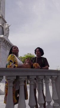 Couple of friends drinking coconut water on vacation