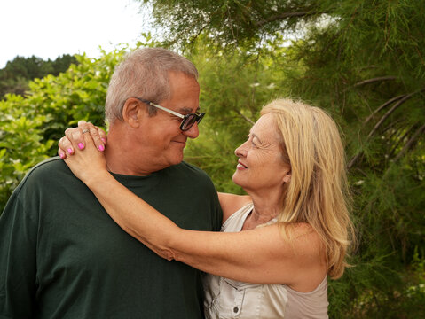 Senior couple embrace outdoors with love and togetherness