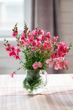 Pink flower bouquet in glass vase on table