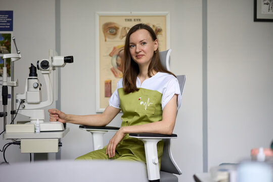 Female ophthalmologist with slit lamp in modern eye clinic