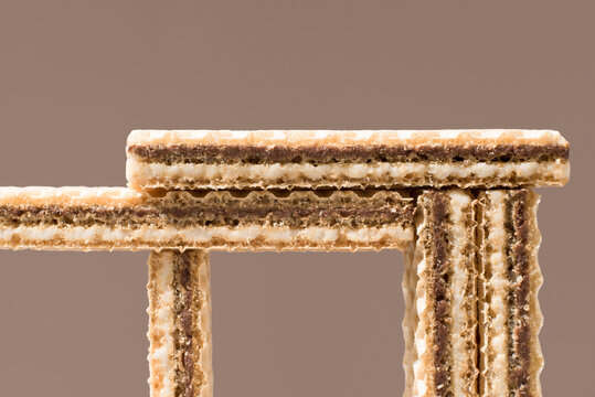 Chocolate wafer cookies arranged on brown background