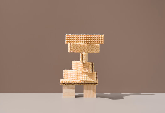 Balanced wafer cookies stack on brown background