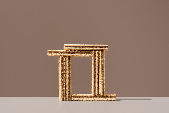 Wafer cookies arranged as a geometric frame on brown background