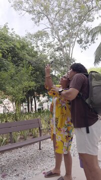Young tourist couple capturing travel memories with a smartphone