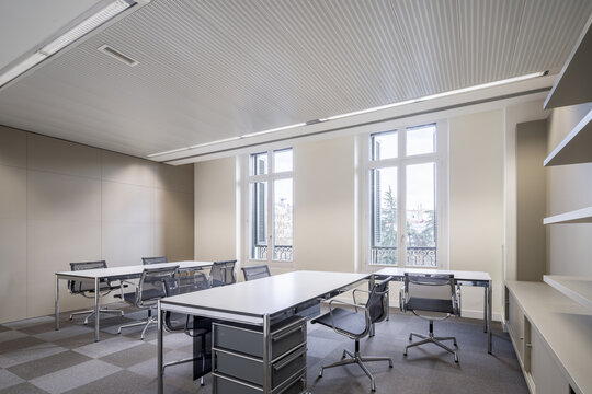 Neoclassical office interior with desks and meeting chairs