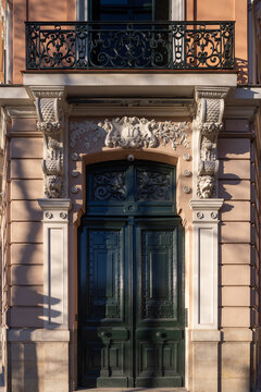 Ornate neoclassical office entrance with carved stone facade