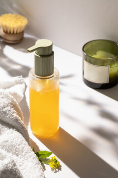 Natural skincare pump bottle with towel and botanical detail