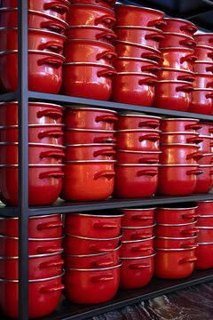 Red cookware display in a modern food hall kitchen