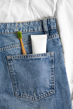 Toothbrush and toothpaste in denim pocket for morning routine