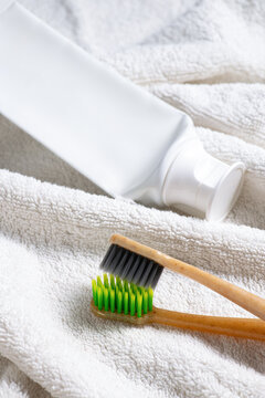 Bamboo toothbrush and toothpaste on towel for dental care