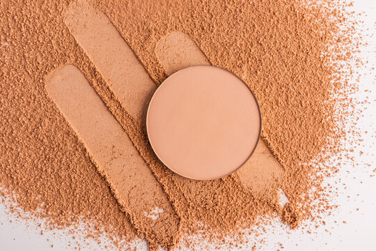 Compact powder makeup swatch with decorative cosmetic layout