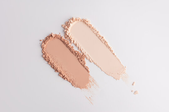 Beige compact powder swatches on light background