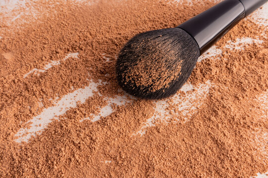 Loose compact powder with cosmetic brush close-up