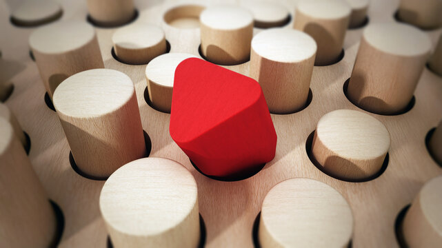 Red prism wooden block standing out among wooden cylinders. 3D illustration