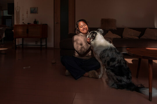 Woman bond with dog in cozy living room at home