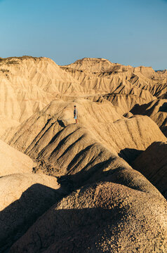 Lone hiker in the eroded Bardenas Reales desert, Spain