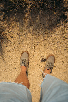 Top view of shoes on cracked dry earth