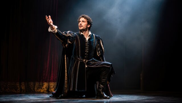 Actor kneeling on stage in a dramatic Renaissance period costume under a spotlight, surrounded by theatrical smoke and velvet curtains, conveying intense emotion and drama
