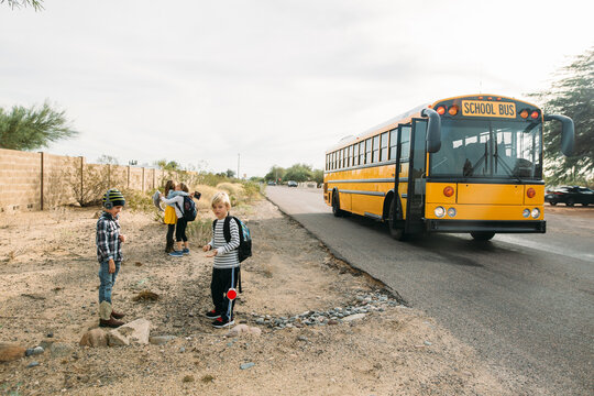 Kids Getting off School Bus in the Desert