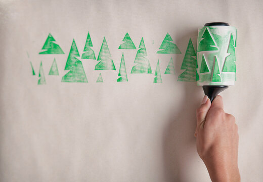 Christmas: A Row Of Inked Christmas Trees Rolled Onto Wrapping Paper