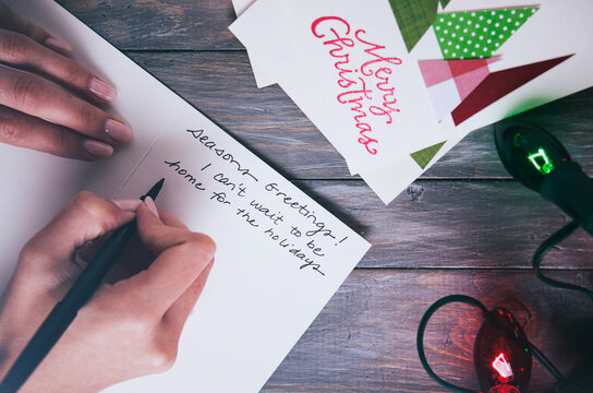 Christmas: Woman Writing Holiday Notes To Family On Handmade Cards