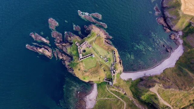 Dunnottar Castle Scotland Aerial View with Slow Rotating and Rising Drone Shot