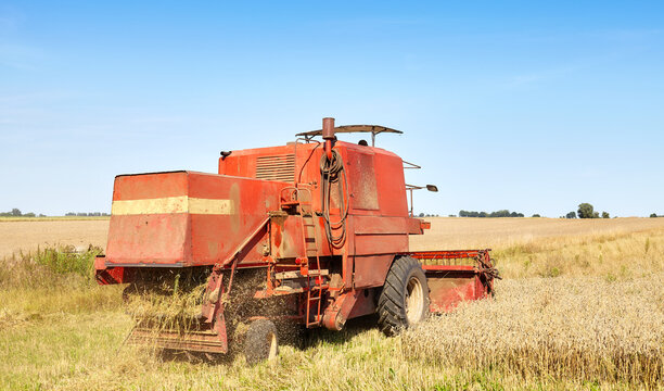 Combine harvesting wheat on a sunny summer day.